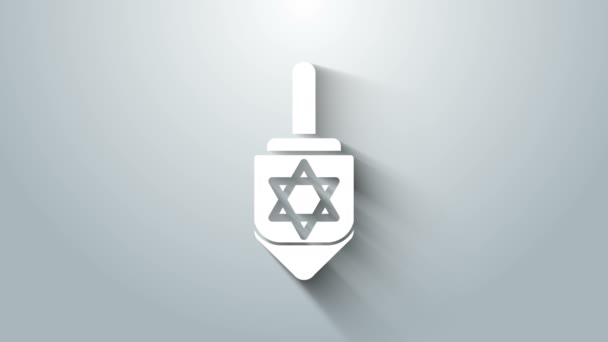 Fehér Hanuka dreidel ikon elszigetelt szürke háttérrel. 4K Videó mozgás grafikus animáció