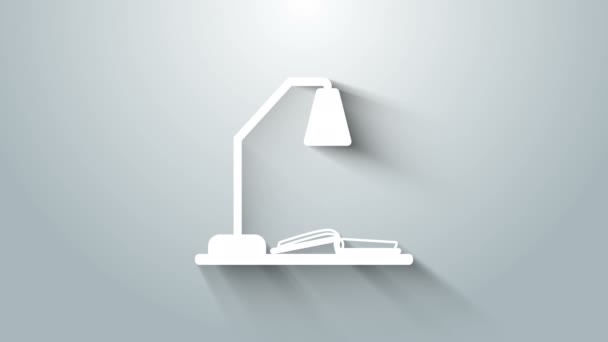 Lugar de trabajo blanco con lámpara de mesa e icono de libro abierto aislado sobre fondo gris. Lámpara de oficina. Animación gráfica de vídeo 4K — Vídeo de stock