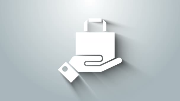 Biała ręka i papierowa ikona torby na zakupy odizolowana na szarym tle. Znak paczki. 4K Animacja graficzna ruchu wideo — Wideo stockowe