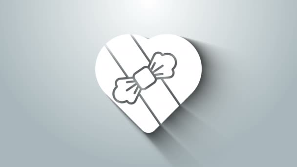 Białe Candy w kształcie serca pudełko i ikona łuku izolowane na szarym tle. Walentynki. 4K Animacja graficzna ruchu wideo — Wideo stockowe
