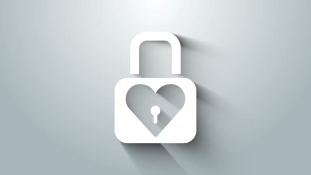 灰色の背景に隔離されたホワイトロックとハートアイコン。心をロックした。愛のシンボルと鍵穴の標識。バレンタインデーのシンボル。4Kビデオモーショングラフィックアニメーション — ストック動画