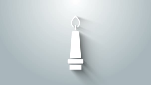 White Burning candle in candlestick icon isolated on grey background. Old fashioned lit candle. Cylindrical candle stick with burning flame. 4K Video motion graphic animation — Stock Video