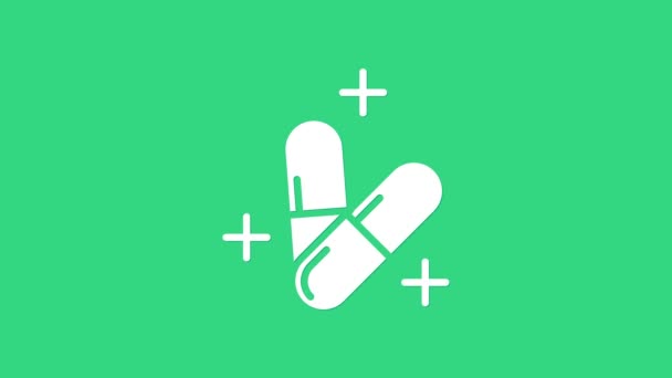White Medicine pill or tablet icon isolated on green background. Capsule pill and drug sign. Pharmacy design. 4K Video motion graphic animation — Stock Video