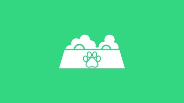 Tazón de comida para mascotas blanco para gato o perro icono aislado sobre fondo verde. Huella de pata de perro o gato. Animación gráfica de vídeo 4K — Vídeo de stock