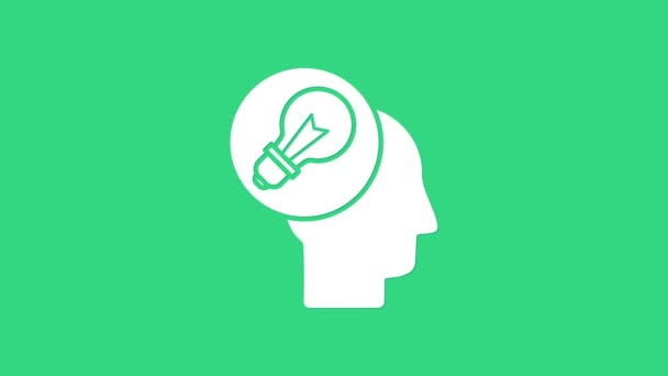 White Human head with lamp bulb icon isolated on green background. 4K Video motion graphic animation — Stock Video