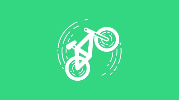緑の背景に隔離されたホワイト自転車トリックアイコン。自転車レースだ。極端なスポーツだ。スポーツ用具。4Kビデオモーショングラフィックアニメーション — ストック動画