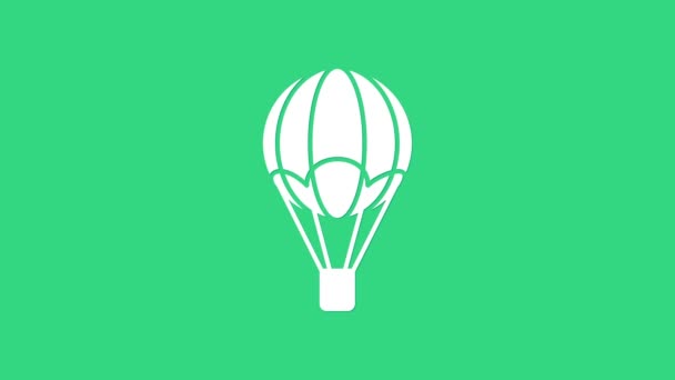緑色の背景に隔離された白い熱気球のアイコン。旅行のための航空輸送。4Kビデオモーショングラフィックアニメーション — ストック動画
