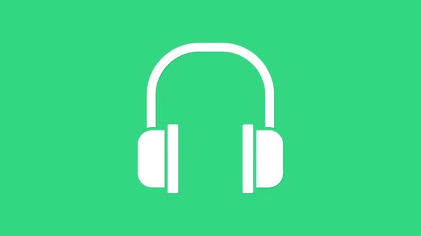 Icono de auriculares blancos aislado sobre fondo verde. Signo de auriculares. Concepto para escuchar música, servicio, comunicación y operador. Animación gráfica de vídeo 4K — Vídeo de stock