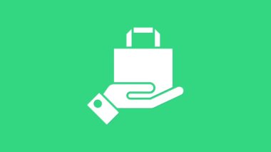 Beyaz El ve kağıt poşet ikonu yeşil arka planda izole edilmiş. Paket işareti. 4K Video hareketli grafik canlandırması