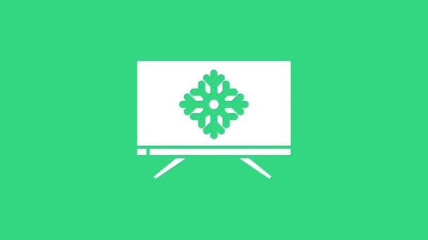 White Merry Christmas on television and snowflake icon isolated on green background. Happy New Year. 4K Video motion graphic animation — Stock Video