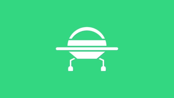 Icono blanco de la nave espacial UFO volando aislado sobre fondo verde. Platillo volador. Nave espacial alienígena. Objeto volador desconocido futurista. Animación gráfica de vídeo 4K — Vídeos de Stock