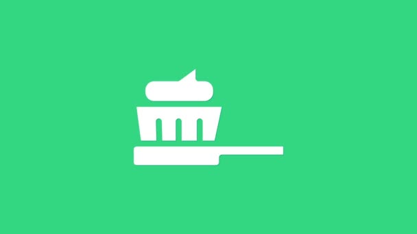 Bílý kartáček se zubní pastou ikonu izolované na zeleném pozadí. Grafická animace pohybu videa 4K — Stock video