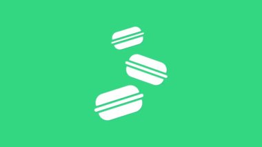 Yeşil arka planda beyaz makarna kurabiye ikonu var. Makarna tatlı fırın. 4K Video hareketli grafik canlandırması