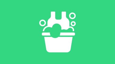 Yeşil zemin üzerinde sabun köpükleri olan beyaz plastik leğen. Sulu kase. Çamaşır yıkama, temizlik malzemeleri. 4K Video hareketli grafik canlandırması