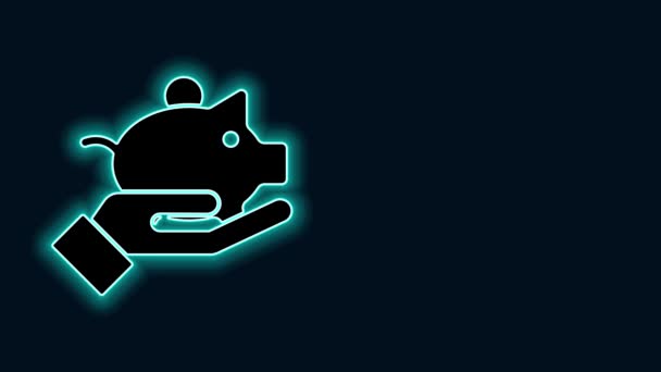 Glowing neon line Piggy bank in hand icon isolated on black background. Icon saving or accumulation of money, investment. 4K Video motion graphic animation — Stock Video
