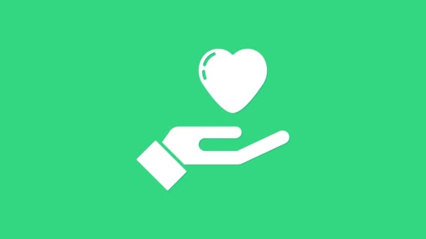 Wit Hart in de hand pictogram geïsoleerd op groene achtergrond. Hand geven liefdessymbool. Valentijnsdag symbool. 4K Video motion grafische animatie — Stockvideo