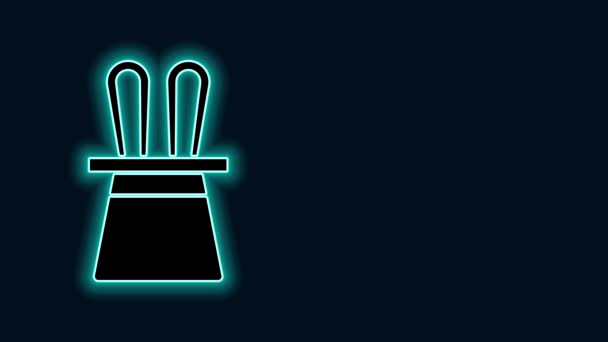 Glowing neon line Topi penyihir dan ikon telinga kelinci Terisolasi pada latar belakang hitam. Trik sulap. Konsep hiburan misteri. Animasi grafis gerak Video 4K — Stok Video