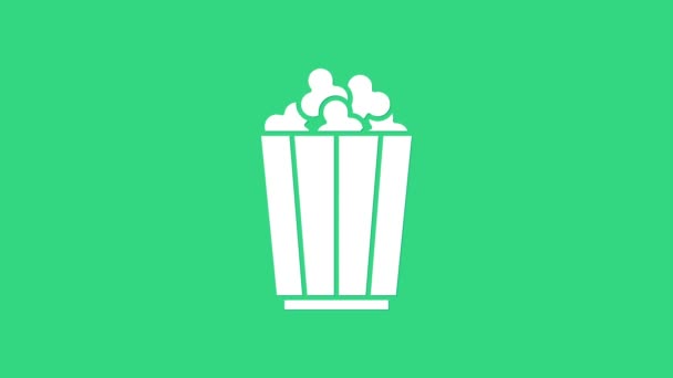 緑の背景に隔離された段ボール箱のアイコンの白いポップコーン。ポップコーンバケツボックス。4Kビデオモーショングラフィックアニメーション — ストック動画