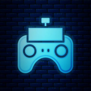 Parlayan neon uzaktan kumanda simgesi tuğla duvar arka planında izole edildi. Vektör.