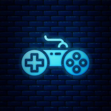Parlayan neon oyun alanı simgesi tuğla duvar arka planında izole edildi. Oyun kontrolörü. Vektör.
