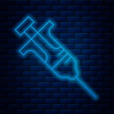 Parlayan neon hattı şırınga ikonu tuğla duvar arkasında izole edildi. Aşı için şırınga, aşı, iğne, grip aşısı. Tıbbi ekipman. Vektör.