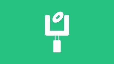 Beyaz Amerikan futbolu kale direği ve yeşil arka planda izole edilmiş futbol topu ikonu. 4K Video hareketli grafik canlandırması