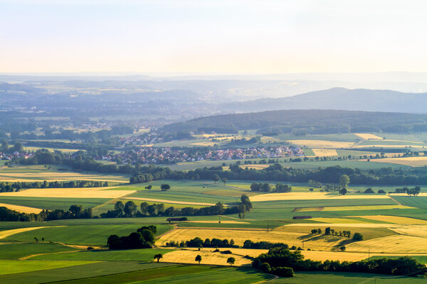 Idyllic Spring countryside Landscape. Farmland, Villages, Hills and Meadows