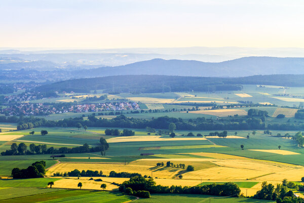 Idyllic Spring countryside Landscape. Farmland, Villages, Hills and Meadows