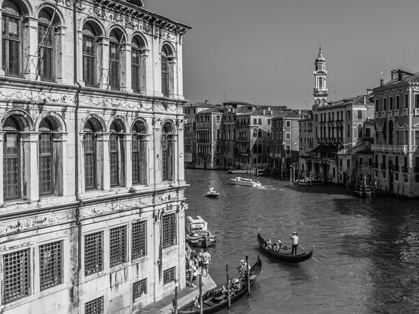 VENICE, ITALY - SEPTEMBER 06 2013: Scene from the Canals of Venice. Boats on the water. Old Architecture. Sunny Blue Sky