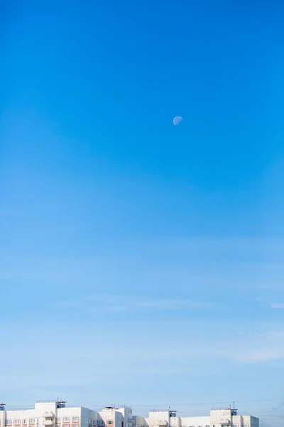 moon and blue sky with clouds