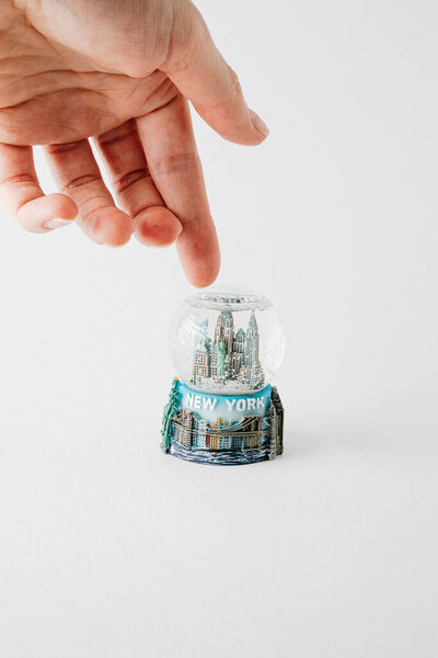 Statue of Liberty in the snow globe glass ball. New York City snow globe. Christmas bauble over snowy background with copy space.