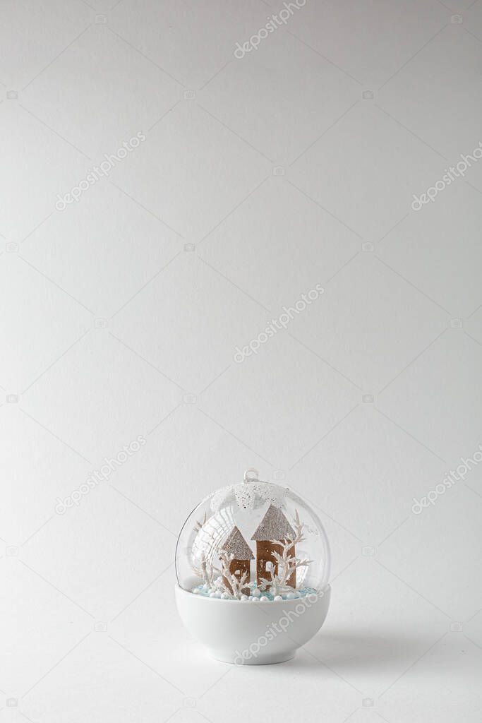 Christmas snow ball with house inside it and snowfall