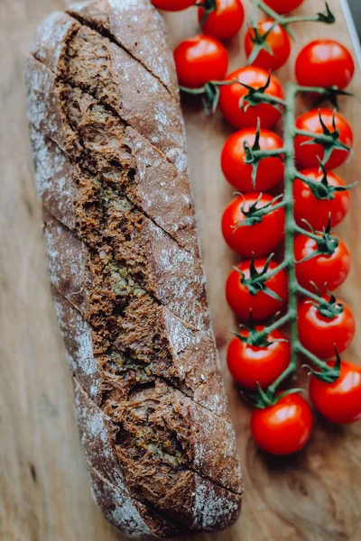 Baked garlic baguette bread with herbs and tomatos