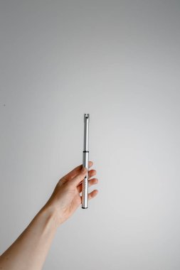 Kadın eli plazma çakmağı tutuyor. Beyaz arkaplan.