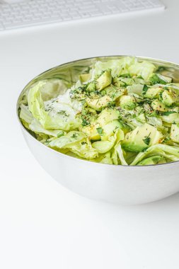 Beton arka planda avokado ve sos ile taze karışık salata. Buzdağından organik sağlıklı salata, avokado ve zeytinyağı ve susam tohumlu salatalık. Sağlıklı yeşil salata.. 