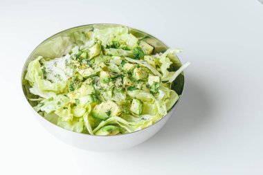 Beton arka planda avokado ve sos ile taze karışık salata. Buzdağından organik sağlıklı salata, avokado ve zeytinyağı ve susam tohumlu salatalık. Sağlıklı yeşil salata.. 