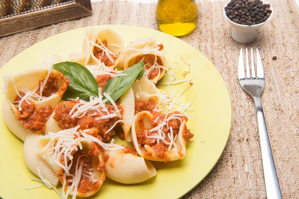 Macaroni with meal and green basil — Stock Photo, Image