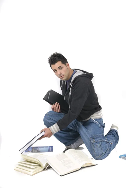 Joven con muchos libros en el suelo —  Fotos de Stock