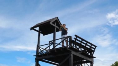 Blogger or Vlogger Male Recording Video on Smartphone at Nature