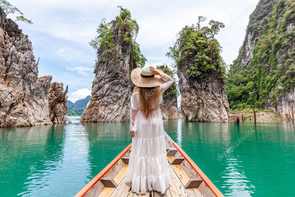 Young Female Tourist in Hat at Longtail Boat Exploring Turquoise Cheow Lan Lake