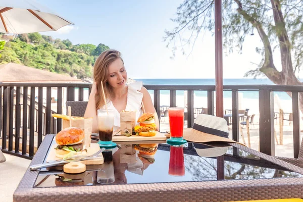 Travel Woman with Fast-food, Burgers, Coffee and Juice Drinks at Outdoor Cafe