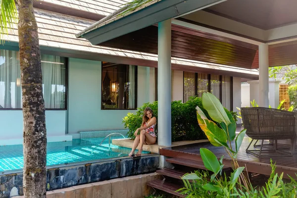 Young Woman in Swimwear Sitting near Swimming Pool on Tropical Luxury Villa — Stock Photo, Image