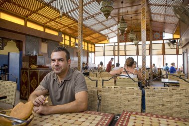 Tourist in Morocco eating bread clipart