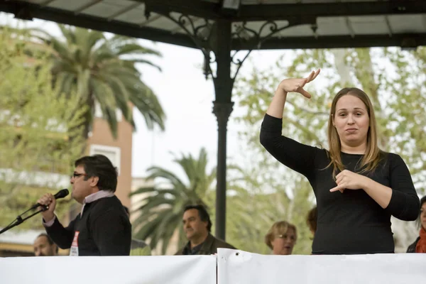 Sign language woman interpreter gestures during a meeting