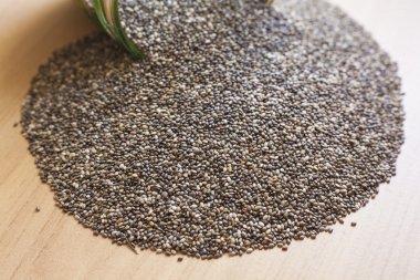 Cam kavanoz chia tohum ile ahşap yüzey üzerine döktüm