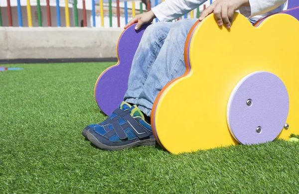 Child Boy Yellow Playground Slide Artificial Green Grass Floor Selective — Stock Photo, Image