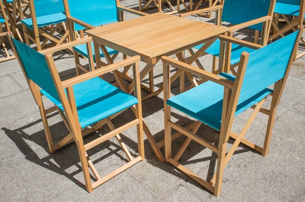 Downtown restaurant terrace with folding canvas chairs. Terrace restaurant furniture concept