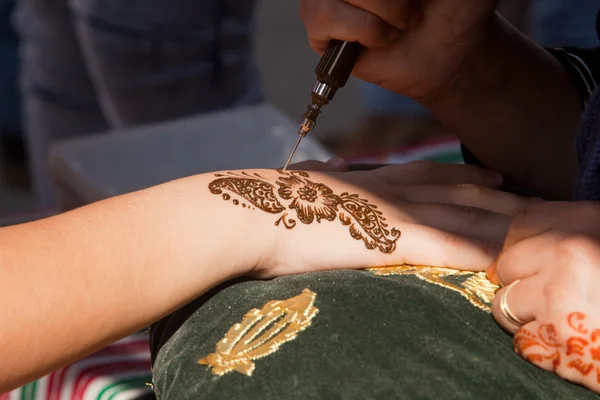 Henna being applied