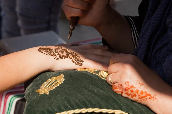 Henna being applied