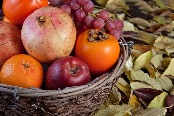 Wicker basket full of autumn fruits